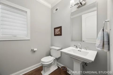 a bathroom with a sink a toilet and mirror