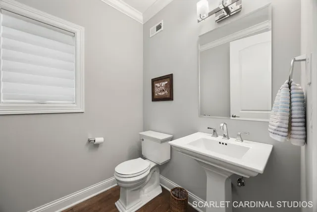 a bathroom with a sink a toilet and mirror