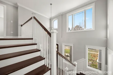 a view of staircase with wooden floor and windows