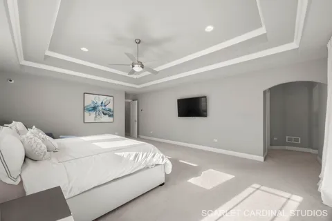 a bedroom with a large bed and a tv
