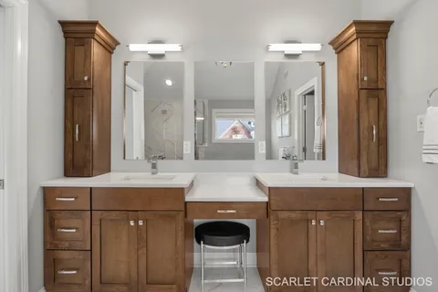 a bathroom with a sink double vanity granite and a mirror