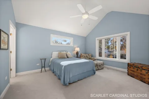 a spacious bedroom with a bed couch and window