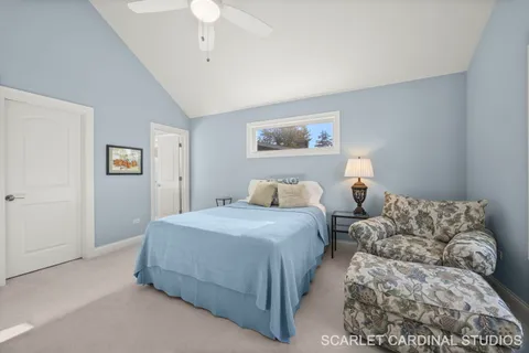 a bedroom with bed and a chandelier