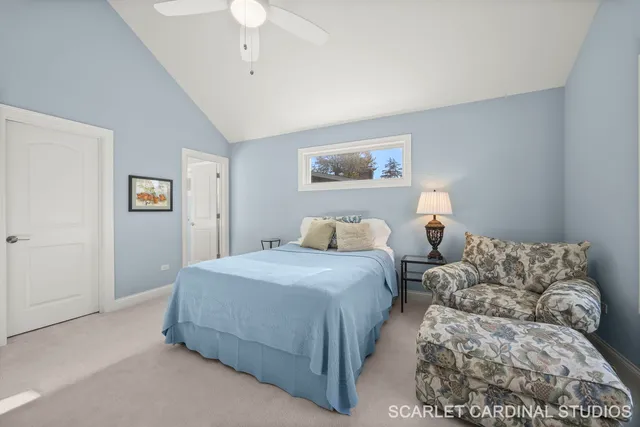 a bedroom with bed and a chandelier