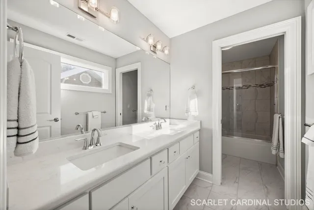 a bathroom with a double vanity sink mirror and