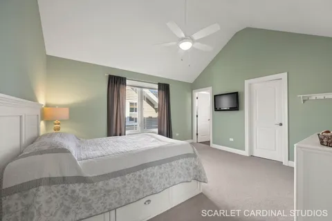 a bedroom with a large bed and a chandelier