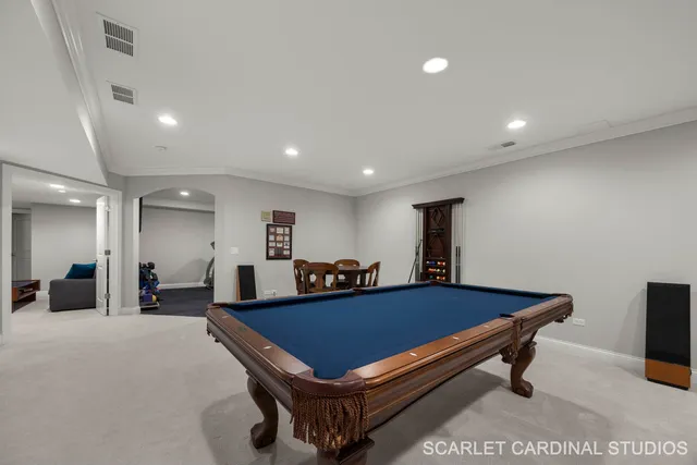 a room with pool table and windows