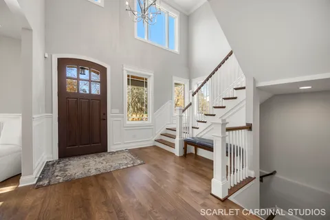 a view of entryway and hall with wooden floor