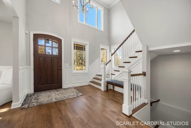 a view of entryway and hall with wooden floor