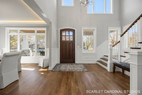 a view of an entryway with wooden floor and windows