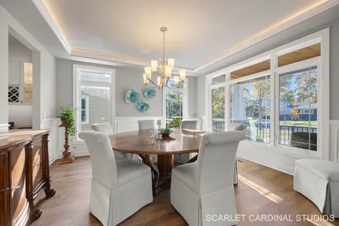a view of a dining room with furniture large windows and wooden floor