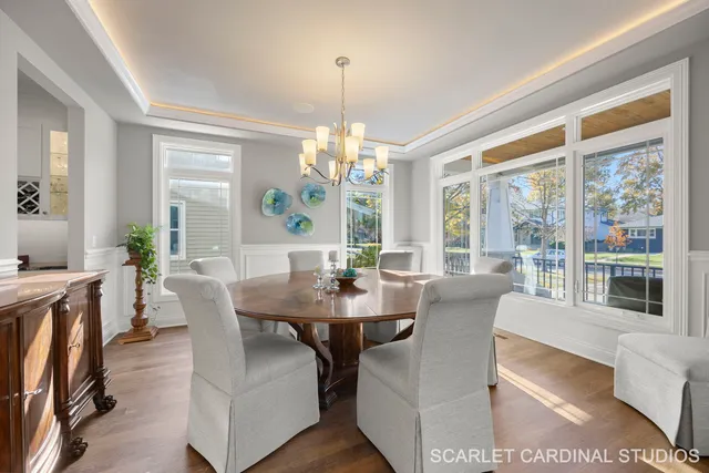 a view of a dining room with furniture large windows and wooden floor