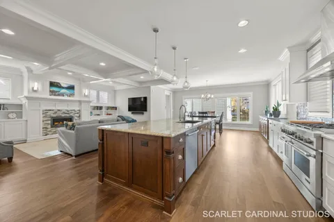 a large kitchen with stainless steel appliances lots of counter space and windows