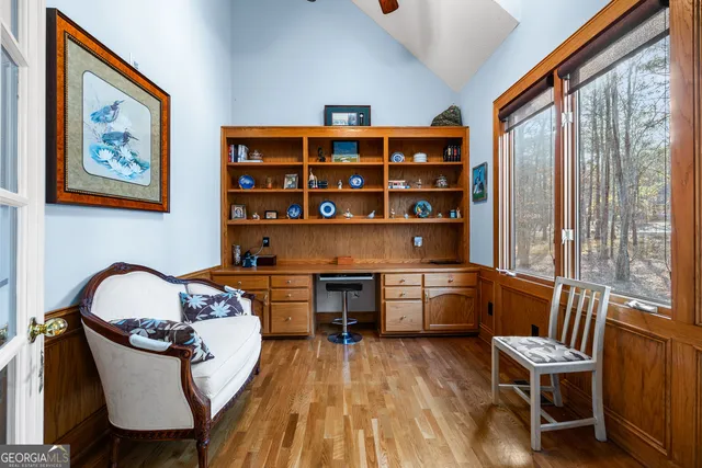 a living room with furniture a fireplace and a floor to ceiling window
