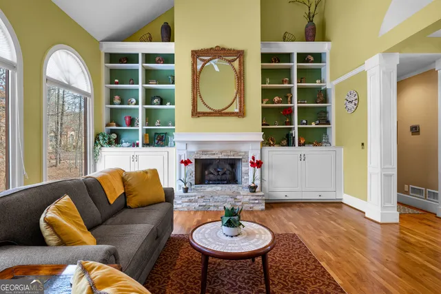 a balcony with wooden floor table and chairs