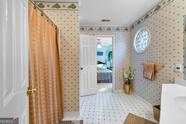 a bathroom with a toilet a sink and shower