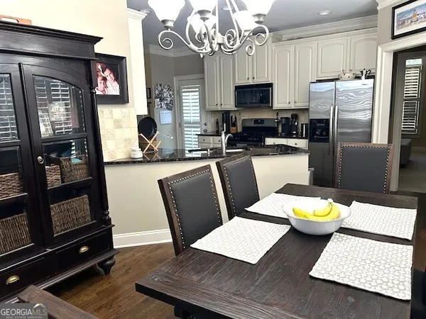a kitchen with stainless steel appliances granite countertop a refrigerator a stove and a sink