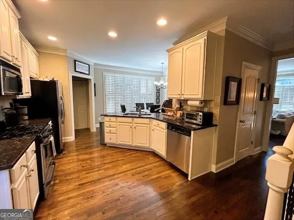a kitchen with stainless steel appliances a stove refrigerator and a sink