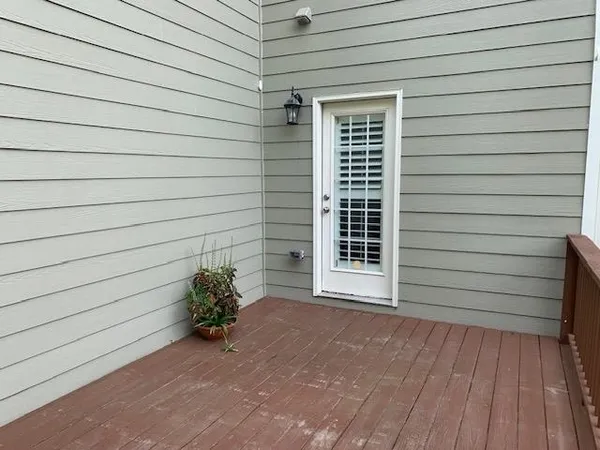 a balcony with wooden floor and trees