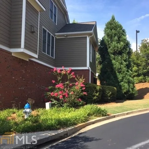 a view of a house with a yard and a garden