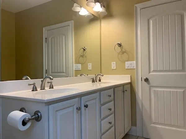 a white toilet sitting next to a bath tub