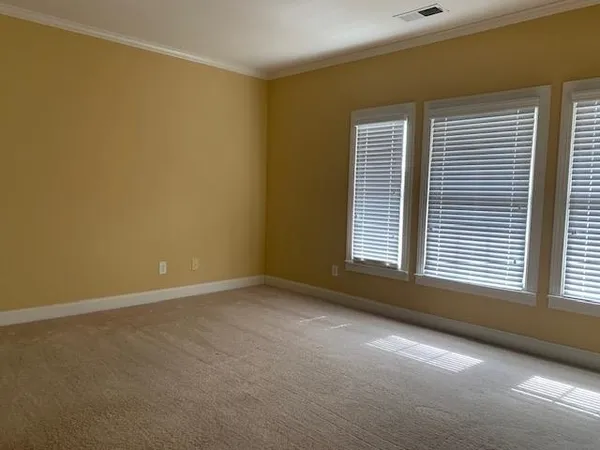 an empty room with closet and mirror