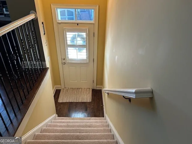 a view of an empty room with exposed radiator and fireplace