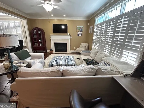 a living room with furniture and wooden floor