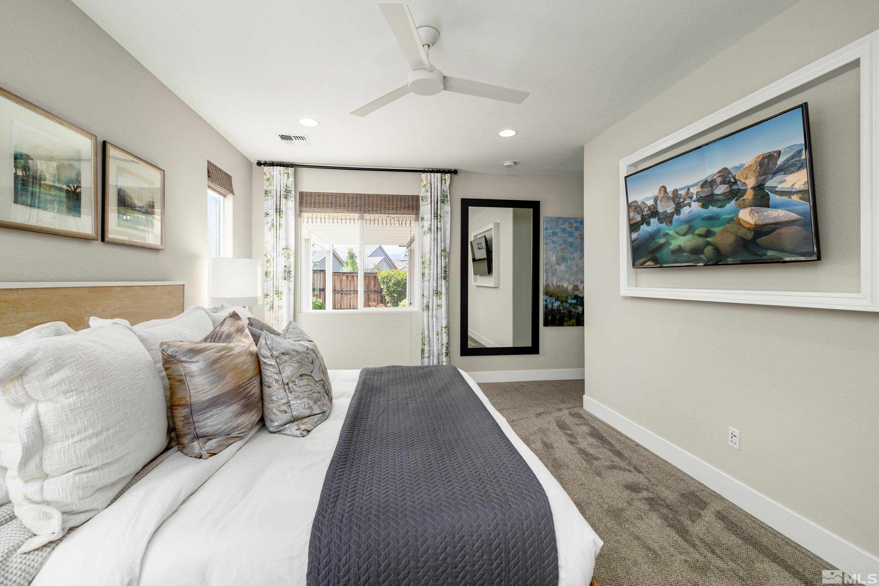 9940 Bernborough Drive Reno, NV 89521 - Photo 13 of 40 a spacious bedroom with a bed and a painting on the wall