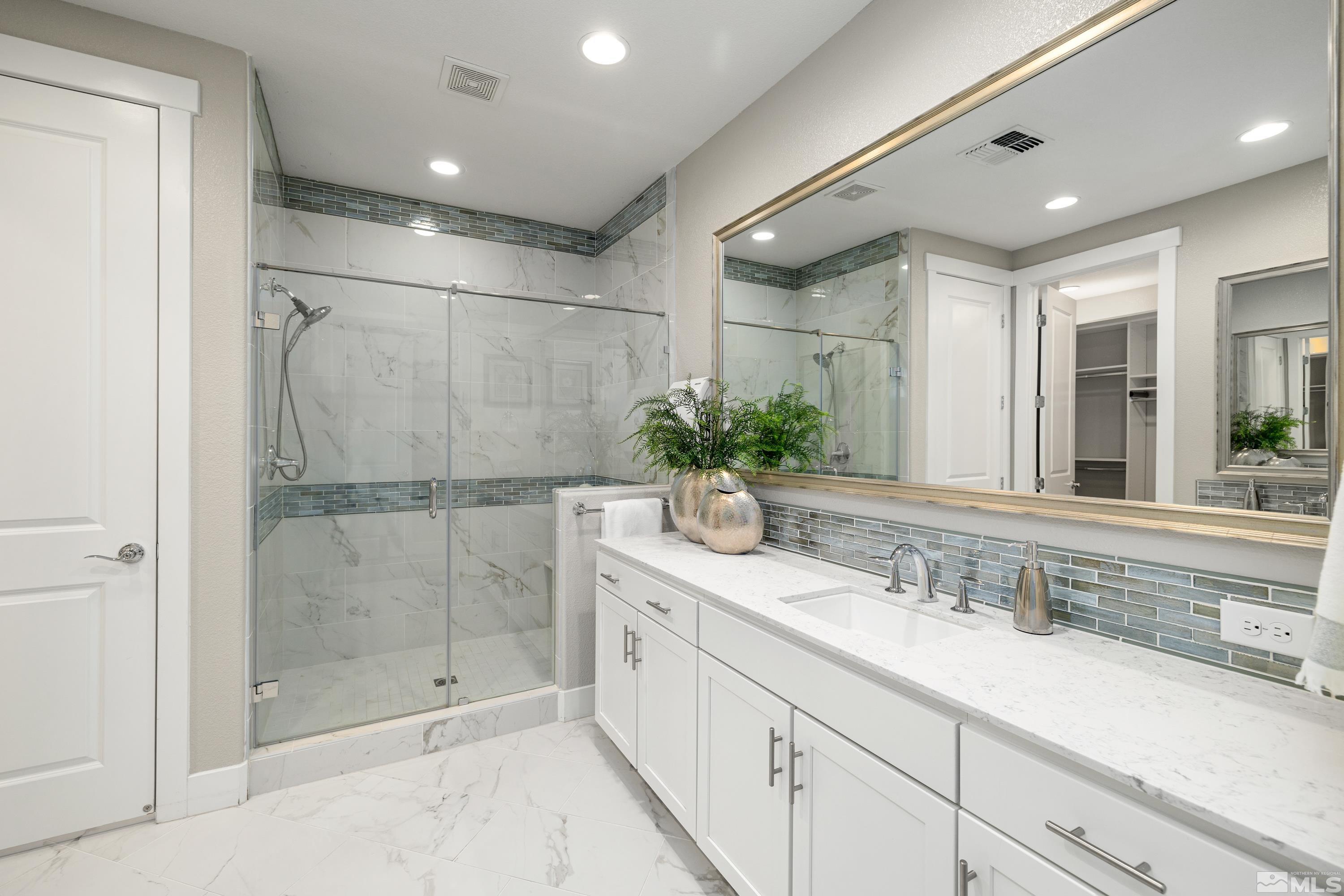 9940 Bernborough Drive Reno, NV 89521 - Photo 14 of 40 a bathroom with a shower sink and mirror