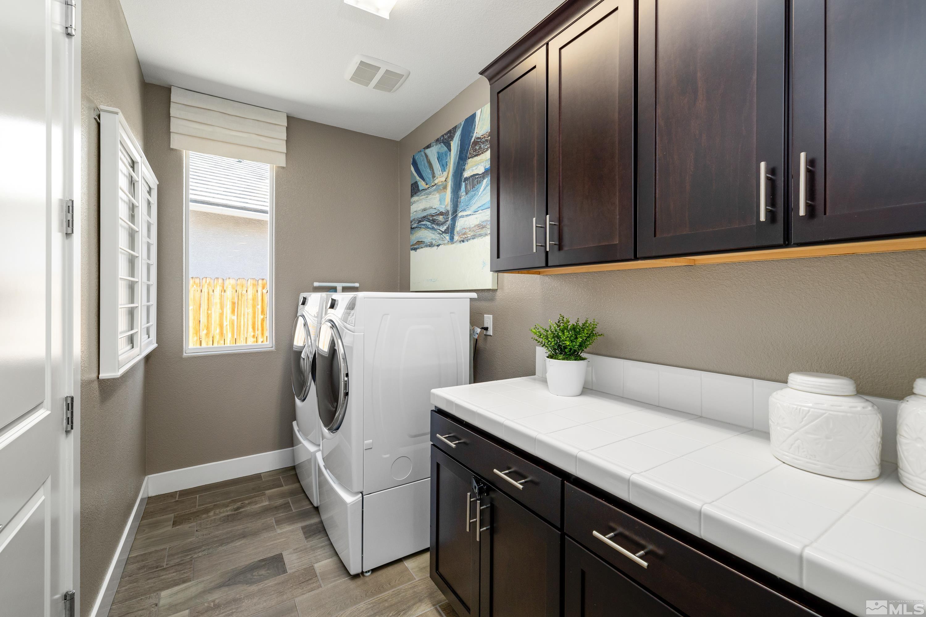 9940 Bernborough Drive Reno, NV 89521 - Photo 20 of 40 a utility room with cabinets washer and dryer