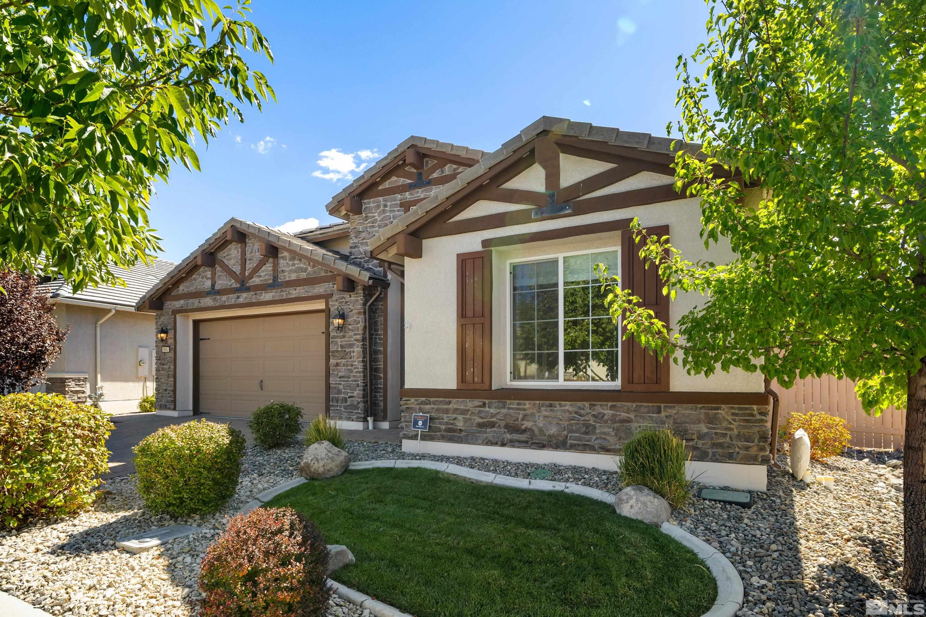 9940 Bernborough Drive Reno, NV 89521 - Photo 2 of 40 a front view of a house with a garden