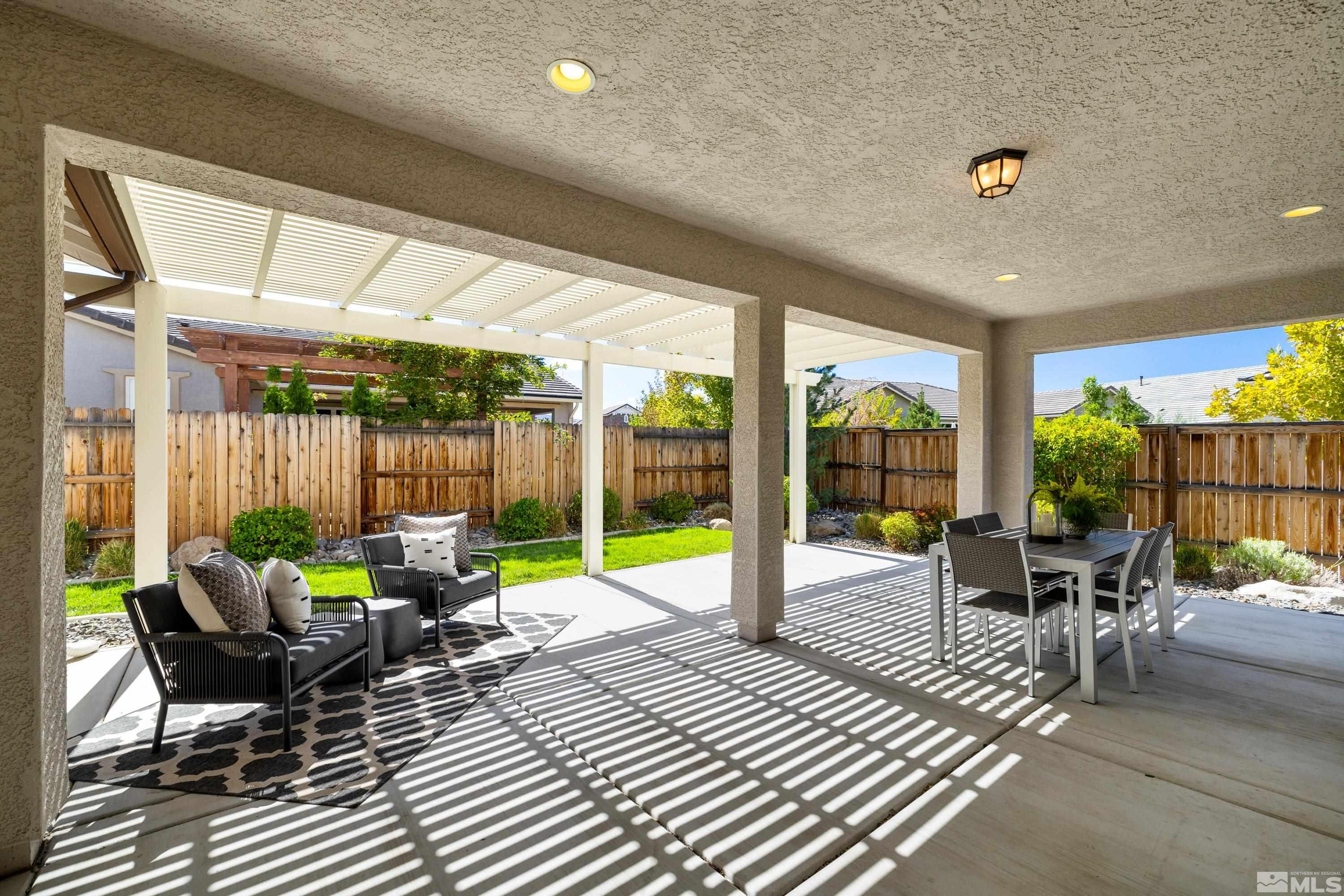 9940 Bernborough Drive Reno, NV 89521 - Photo 21 of 40 a view of a patio with a dining table and chairs