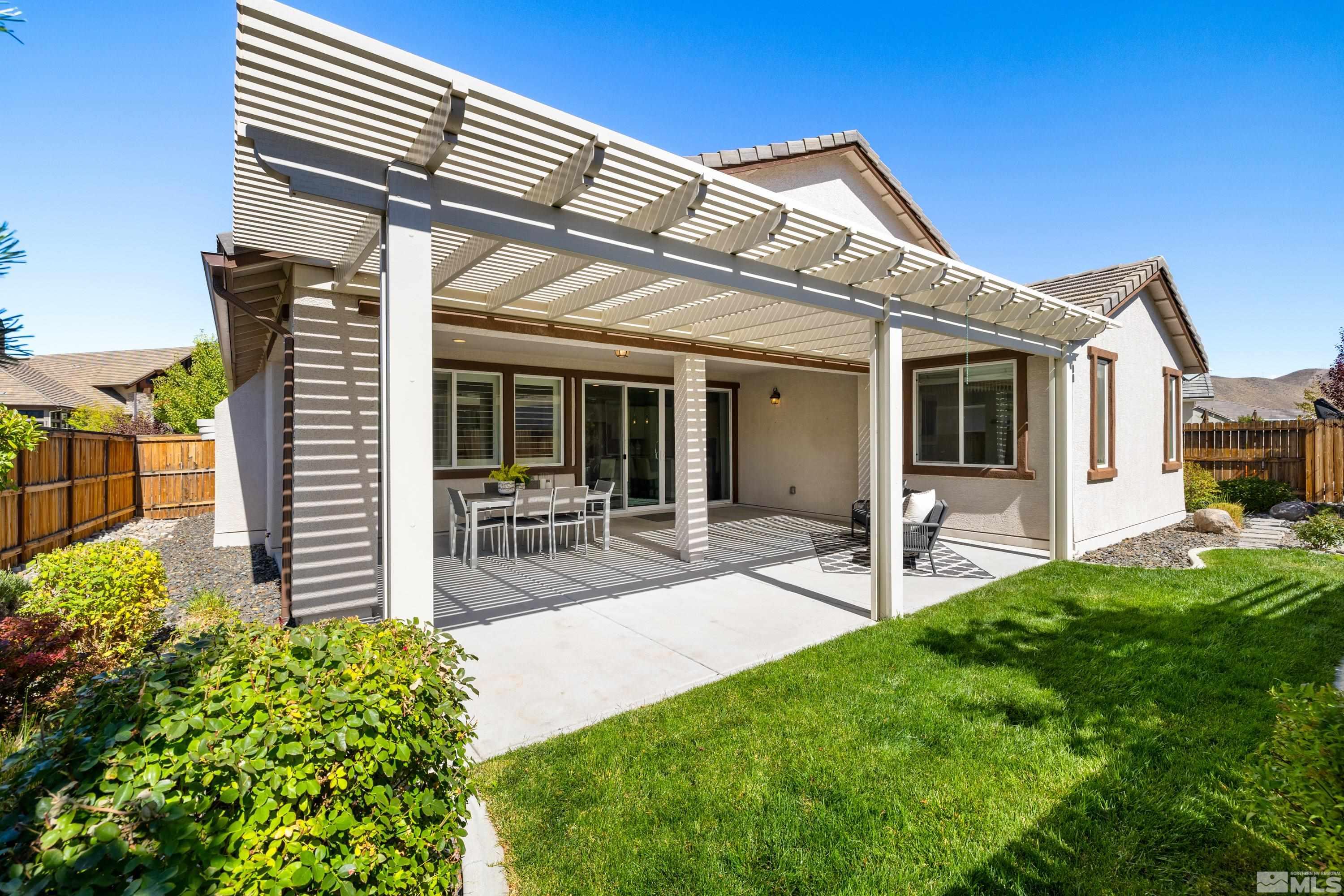 9940 Bernborough Drive Reno, NV 89521 - Photo 22 of 40 a front view of a house with a garden and plants