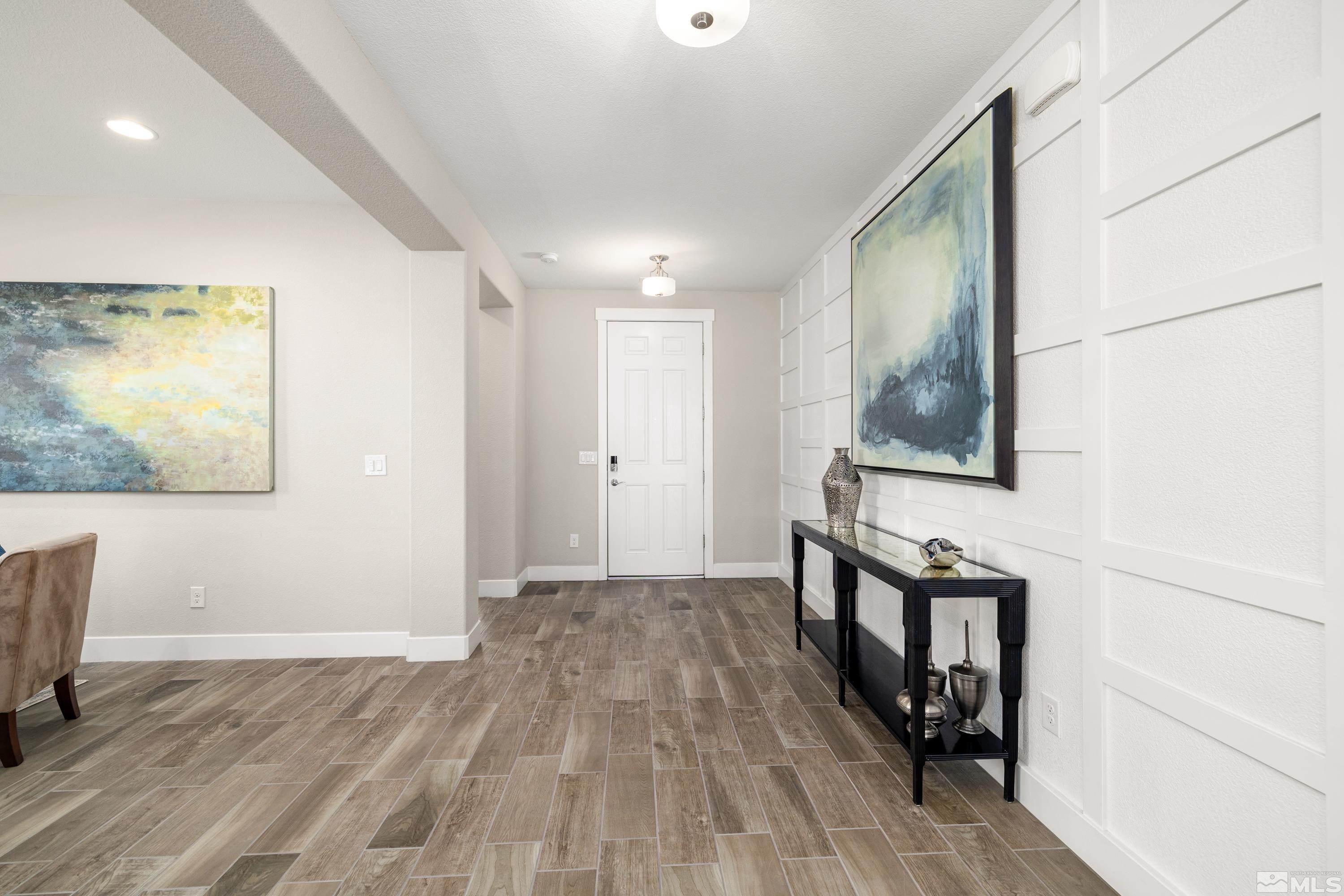 9940 Bernborough Drive Reno, NV 89521 - Photo 3 of 40 a view of hallway with wooden floor and staircase