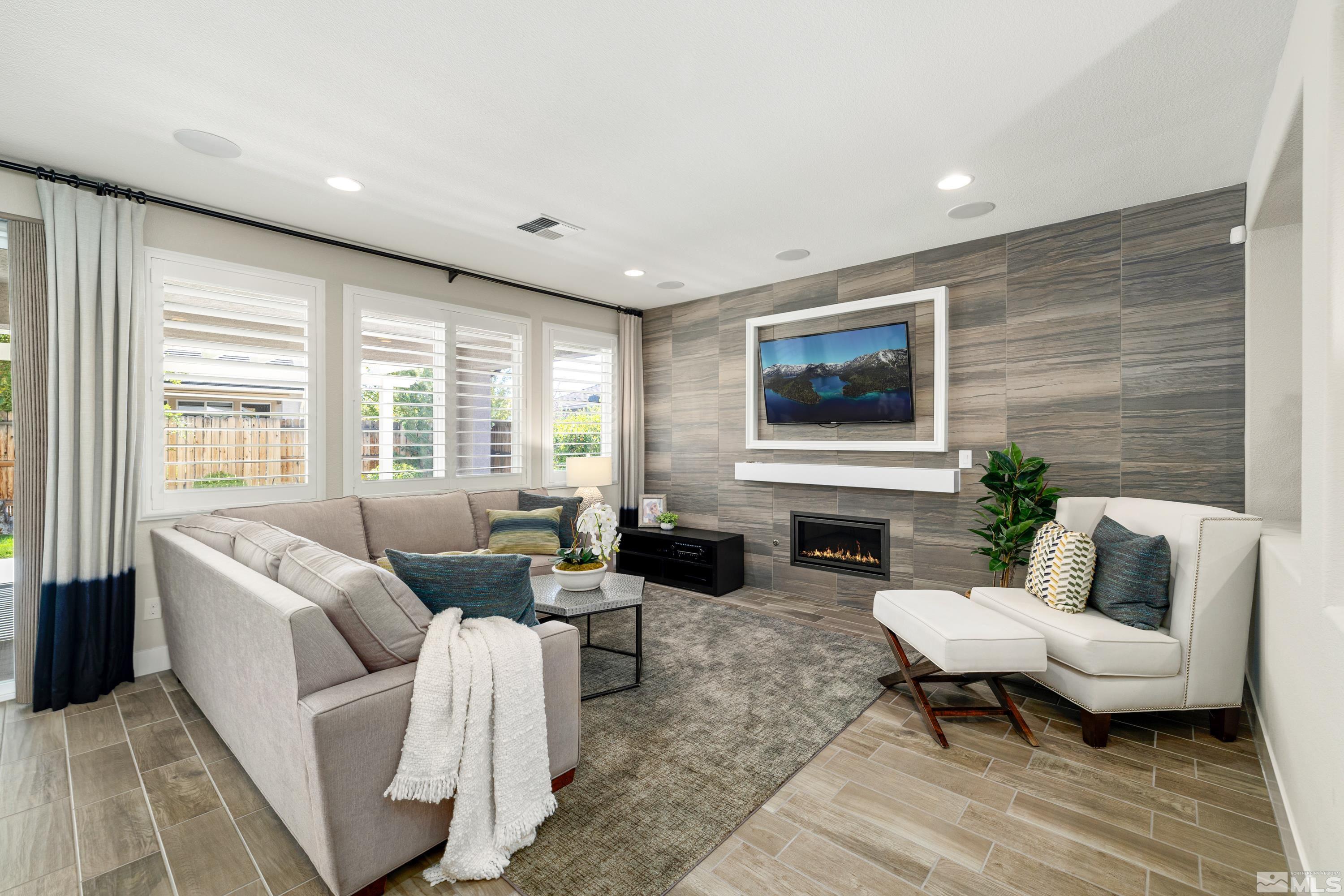 9940 Bernborough Drive Reno, NV 89521 - Photo 4 of 40 a living room with furniture and a flat screen tv