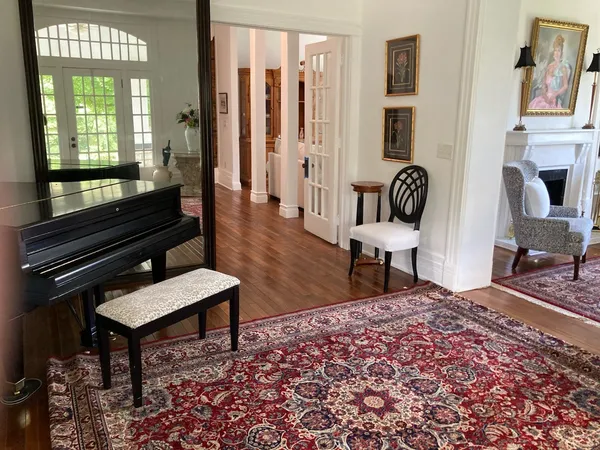 a view of hall way with furniture and wooden floor
