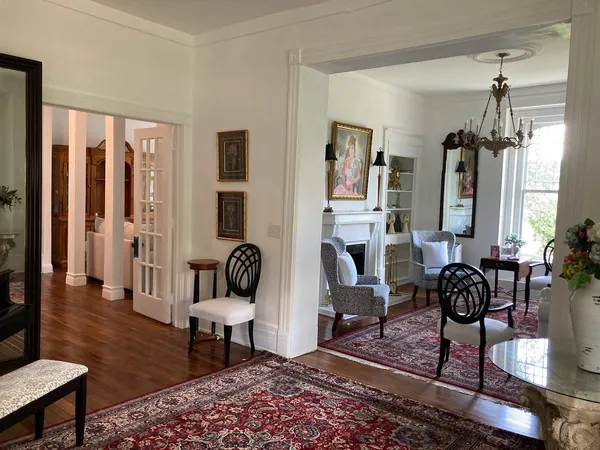 a living room with furniture rug and wooden floor