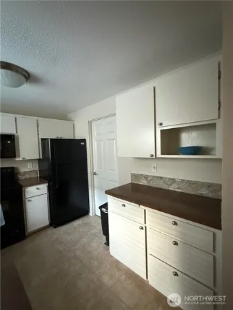 a kitchen with a refrigerator and a sink