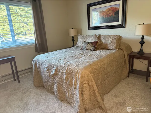 a bedroom with bed and a chair