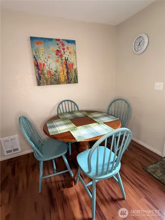 a view of a dining room with furniture and wooden floor