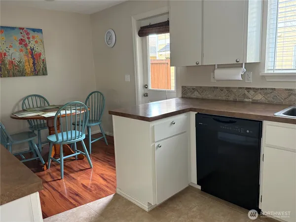 a kitchen with granite countertop dining table chairs and a sink