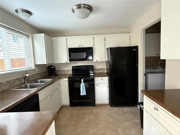 a kitchen with a refrigerator a sink and a stove