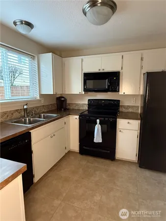 a kitchen with stainless steel appliances granite countertop a stove a sink dishwasher and a refrigerator