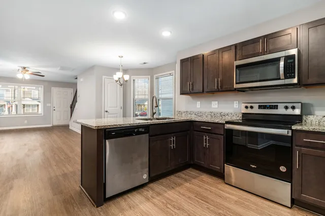 a kitchen with a sink and steel cabinets