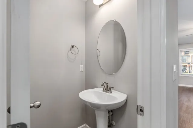 a bathroom with a sink a mirror and a toilet