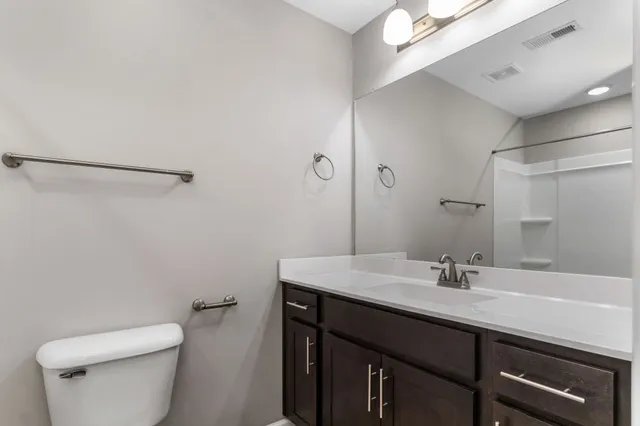 a bathroom with a sink toilet and vanity