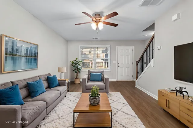 a living room with furniture and wooden floor