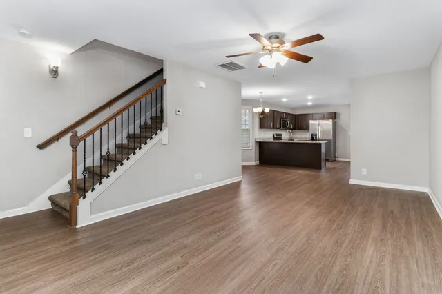 a view of kitchen and hall with wooden floor