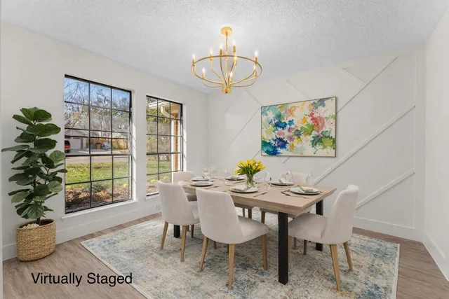a view of a dining room with furniture window and wooden floor